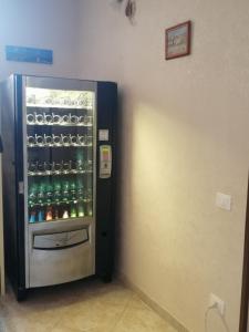 a refrigerator filled with lots of bottles of beer at San Gaetano bed in Naples