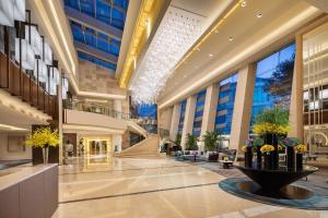 a lobby of a building with a fountain in the middle at Crowne Plaza Shanghai Fudan, an IHG Hotel in Shanghai