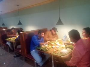 a group of people sitting at tables eating food at Hotel Chembiyan in Pudukkottai +10 photos