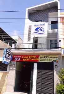 a building with a parking garage in front of it at Nhà nghỉ 89 in Phan Thiet