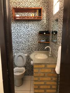 a small bathroom with a toilet and a sink at Casa YeS Jeri in Jericoacoara +19 photos