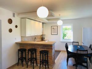 a kitchen and dining room with a table and chairs at Domek Breloka in Buczkowice