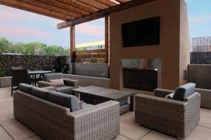 a patio with chairs and a fireplace and a tv at Holiday Inn Express & Suites - The Dalles, an IHG Hotel in The Dalles