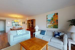 a living room with two couches and a table at Sea Colony - 306 Brandywine in Bethany Beach