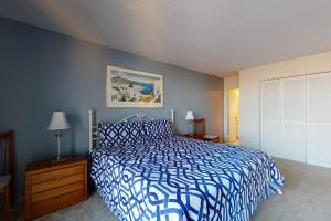 a bedroom with a bed with a blue and white bedspread at Sea Colony - 306 Brandywine in Bethany Beach +23 photos