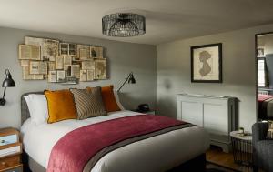 a bedroom with a bed with books on the wall at Hotel Indigo - Bath by IHG in Bath +141 photos