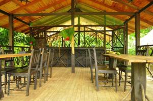 una mesa de madera y sillas en un pabellón en Acuali EcoHostal, en Capurganá