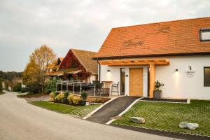 a white house with a red roof at Biohofgut LASCHALT in Deutsch Kaltenbrunn