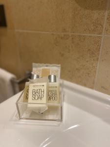 a bathroom sink with a box of bath soap on it at MH Hotel Piacenza Fiera in Piacenza