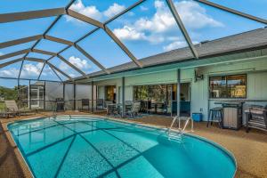 an indoor swimming pool with a large glass ceiling at Barsl Retreat in Cape Coral