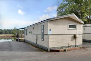 a small building sitting next to a body of water at Discovery Parks - Forster in Tuncurry