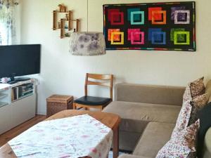 a living room with a couch and a table at One-Bedroom Holiday home in Hjältevad in Svenstorp