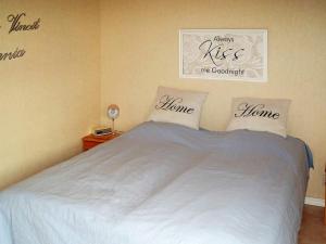 a bedroom with a bed with words on the wall at One-Bedroom Holiday home in Hjältevad in Svenstorp