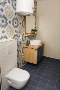 a bathroom with a toilet and a sink at Urban Residence Apartments in Mostar