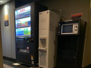 a vending machine and a microwave next to a refrigerator at APA Hotel Nambaminami Ebisucho Eki Shinsekai in Osaka +37 photos