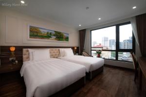 Voodi või voodid majutusasutuse Hillary Hanoi Hotel toas