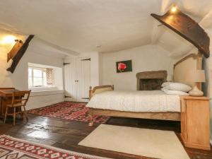 a bedroom with a bed and a desk in it at Hole Farm in Gidleigh