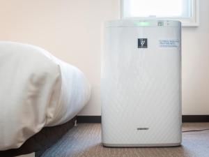 Een bed of bedden in een kamer bij Super Hotel JR Fujiekimae Kinenkan