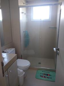 a bathroom with a shower with a toilet and a sink at Vista para o mar in Guarujá