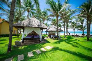 a resort with a gazebo and palm trees on the beach at Pandanus Resort in Mui Ne