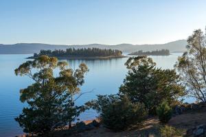 a view of a lake with trees in the foreground at Discovery Parks - Jindabyne in Jindabyne
