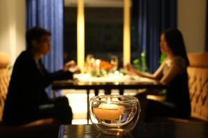 a man and woman sitting at a table in a restaurant at B Hotel Bishkek in Bishkek
