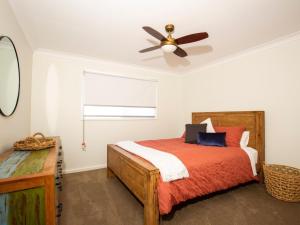 a bedroom with a bed and a ceiling fan at Pagoda at Culburra I Pet Friendly I Newly Renovated in Culburra Beach
