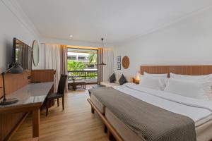 a hotel room with two beds and a large window at Kamala Beach Resort, A Sunprime Resort - SHA Plus in Kamala Beach