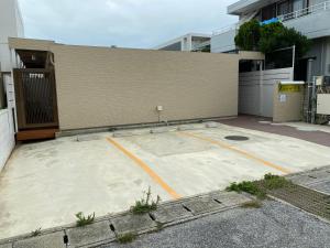 un gran aparcamiento frente a un edificio en L House Miyako Island, en Isla Miyako