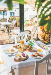 a white table with breakfast food on it at El Hotelito Del Golfo in El Golfo