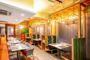 a restaurant with tables and chairs in a room at The Belstead in Chennai