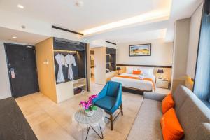 a hotel room with a bed and a couch at J4 Hotels Legian in Legian