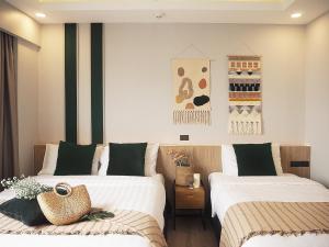 Säng eller sängar i ett rum på Darley Hotel Chiangmai