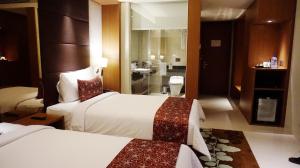 Rúm í herbergi á The Margo Hotel