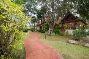 a red brick walkway in front of a house at Ruen Ariya Resort in Mae Rim