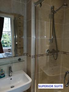 a bathroom with a shower and a sink at Edinburgh City Suites in Edinburgh