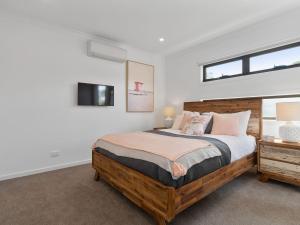 a bedroom with a large bed and a window at Rosebud Beachside Gem in Rosebud