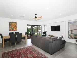 a living room with a couch and a table at Rockwall I Pet Friendly I Fire Pit in Bundanoon