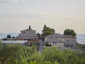 a group of buildings sitting on top of a hill at Montestigliano in Sovicille