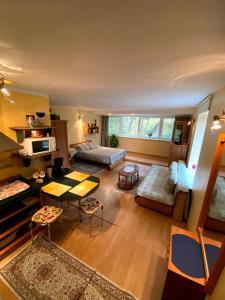 a living room with a couch and a table at Apartamentai Nidoje in Nida