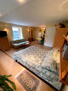 a bedroom with a large bed in a room at Apartamentai Nidoje in Nida +5 photos