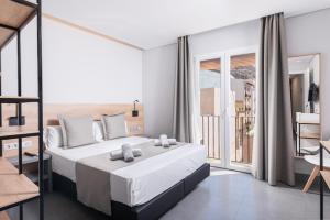 a bedroom with a large white bed and a balcony at Hotel La Milagrosa in Alicante +37 photos