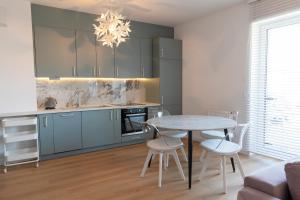 a kitchen and dining room with a table and chairs at Apartamenty na Wzgórzu in Bochnia