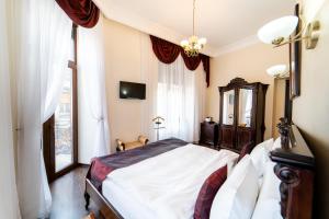 Un dormitorio con una cama grande y una ventana en Picasso Boutique Hotel, en Arad