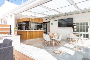 an open kitchen and dining room with a table and chairs at Hotel La Milagrosa in Alicante