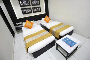 Postel nebo postele na pokoji v ubytování Hotel Paramount Inn