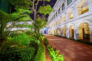 a courtyard of a building with trees and plants at The Grand Imperial - Heritage Hotel in Agra