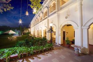 a building with a courtyard with plants and lights at The Grand Imperial - Heritage Hotel in Agra