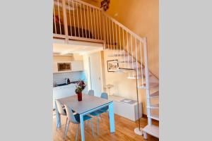 a dining room with a table and a staircase at Studio de Poeti in Bologna