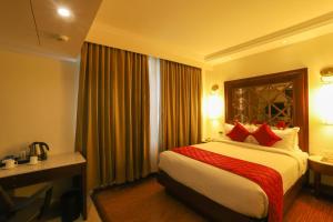 A bed or beds in a room at The Saibaba Hotel
